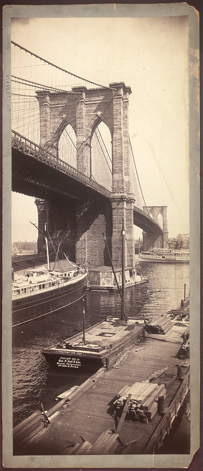 A black-and-white photograph of the Brooklyn Bridge
